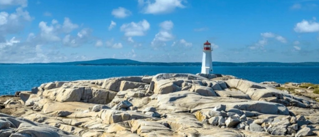 Peggy's Point Lighthouse on granite rocks at Peggy's Cove, Nova Scotia — Halifax shore excursion